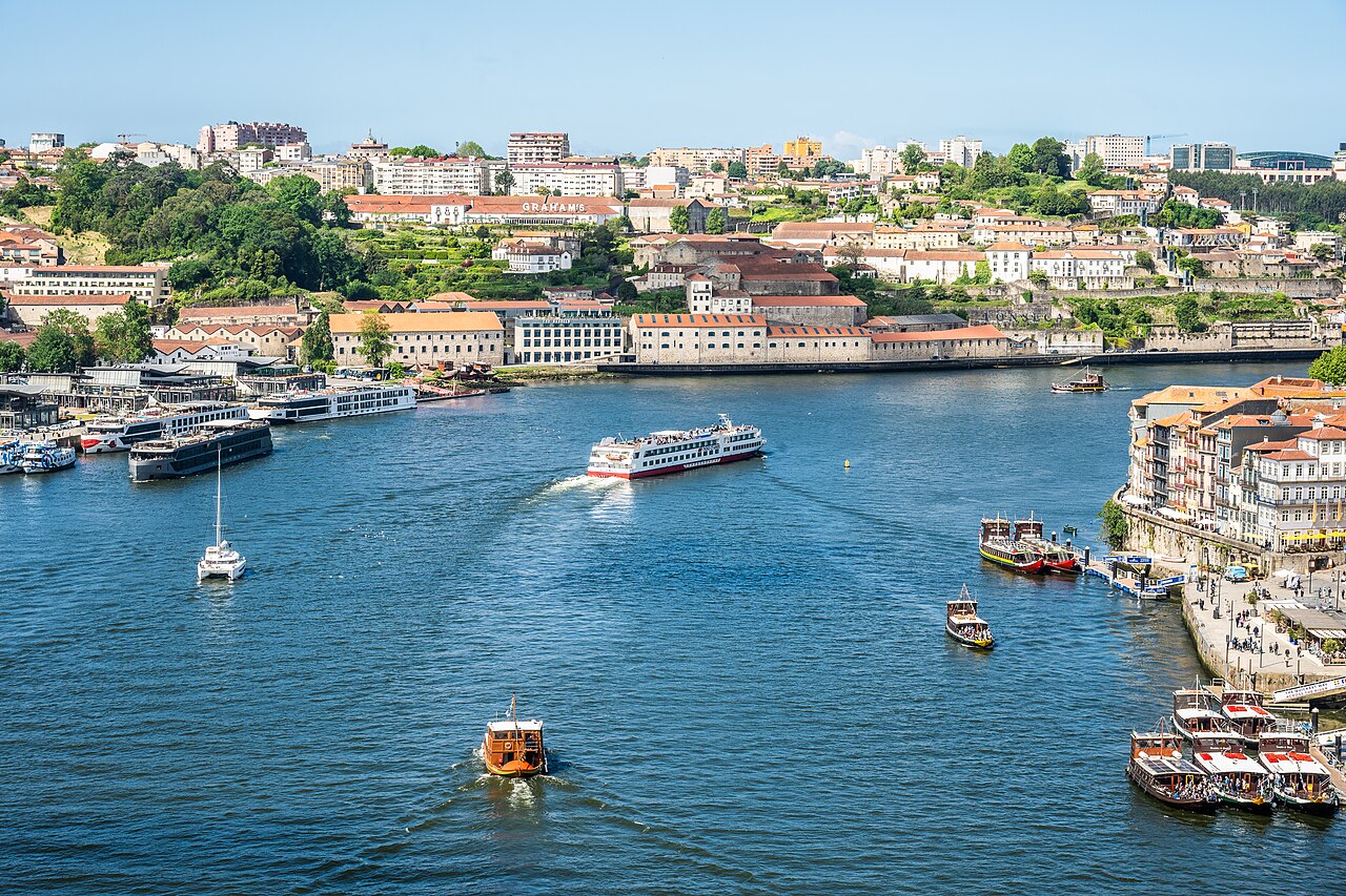 A scenic view of Porto, Portugal, showcasing the Douro River with various boats and the cityscape. (55245838307)
